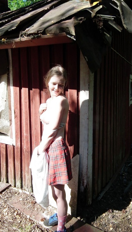 Solo girl displays her tits and twat while forcing entry to an abandoned cabin.