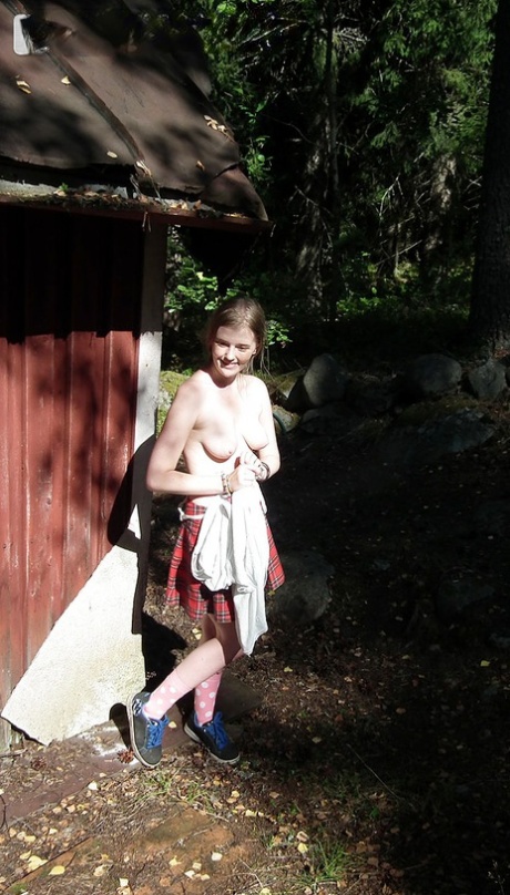 Solo girl exhibits her tits and twat while forcing her way into an abandoned cabin.