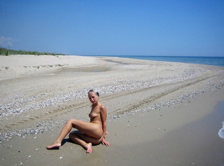 Adele, a blonde amateur, dives into the water while completely unclothed.