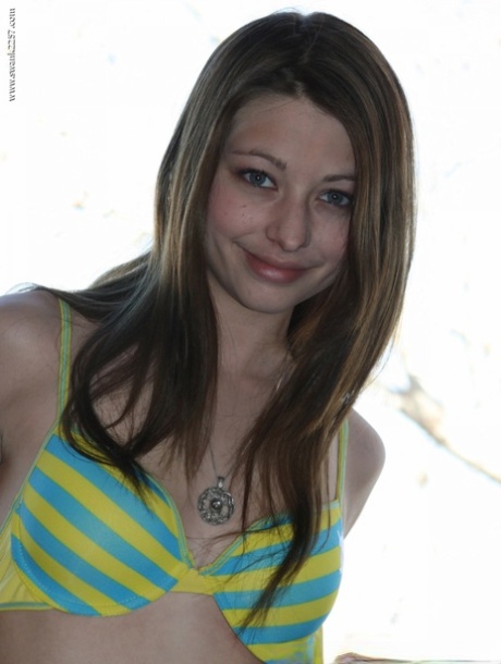 On a balcony of a condo, an amateur girl models herself as a bra and panty.