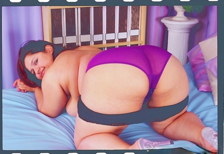 The overweight woman in lingerie playing with her toys.