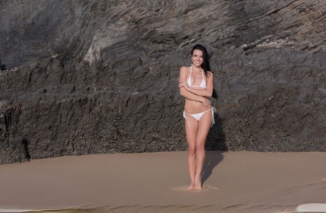 Young Brunette Sapphira Looses Her Bikini To Pose Nude On A Pristine Beach