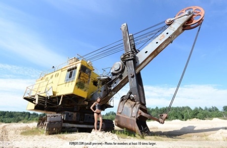 Nice teen Medina U gets totally naked upon heavy equipment during the day