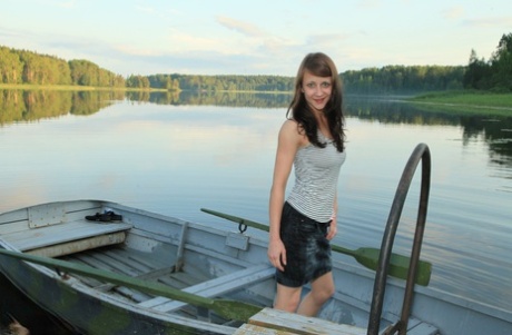 On a dock in the lake, young girl Veronika is nude and makes her debut.
