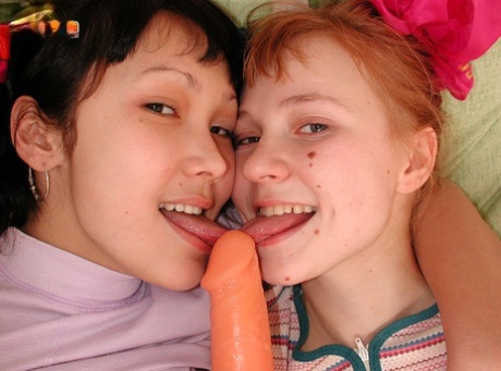 Young Looking Girls Share A Double Ended Dildo During Interracial Lesbian Sex