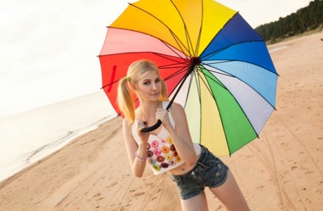 Blonde Teen Candy Holds An Umbrella Before A Nude Finger Fuck At The Beach