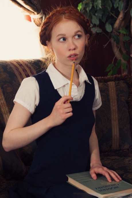 Young looking redhead Dolly Little gets naked in white socks and Mary Jane's