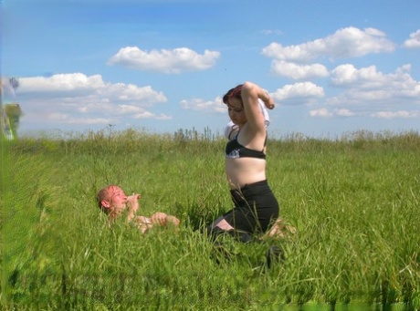 In the middle of a field, a homeless man and an attractive redheaded plumper have sexual intercourse.