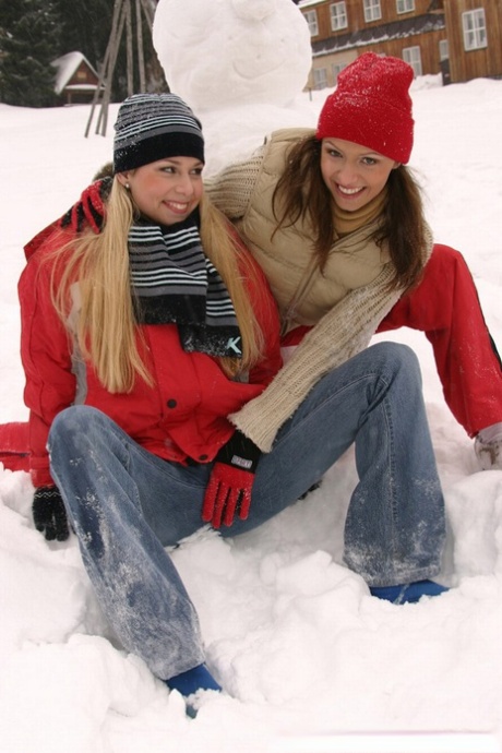 A snowman is constructed by amateur girls in the snow before they engage in sexual activity with the woman.