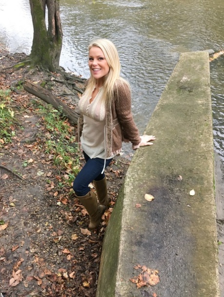 A lazy lady squats over her pants while admiring the scenery among the trees.