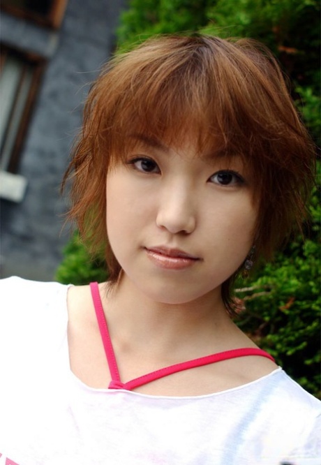 Redhead Japanese teen Madoka Ozava gets totally naked on her bed