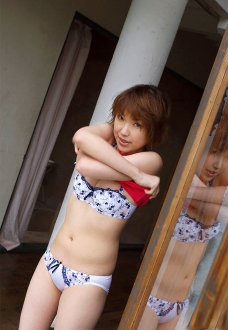 Redhead Japanese teen Madoka Ozava gets totally naked on her bed