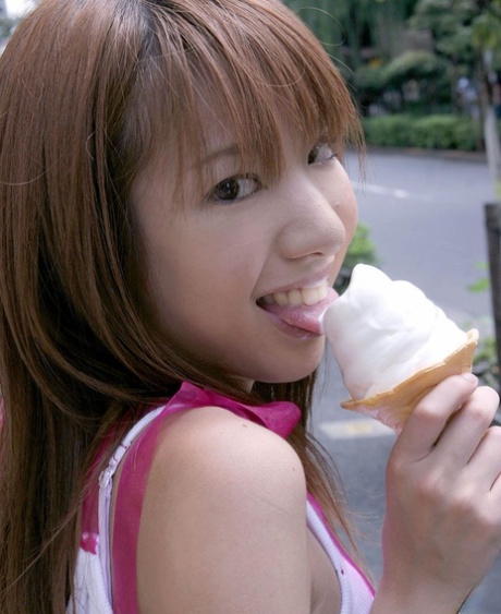 After showing her bra, a young Japanese girl named Yuuna treats herself to an ice cream while kissing.