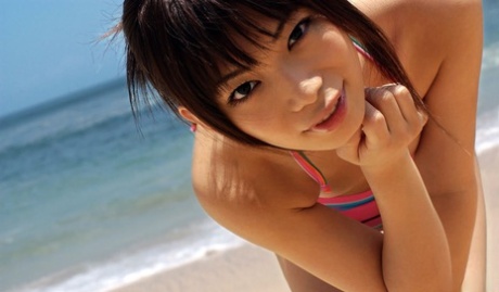 At public places, the beautiful Asian girl Hikari Hino flaunts her genuflect body and attractive facial features.