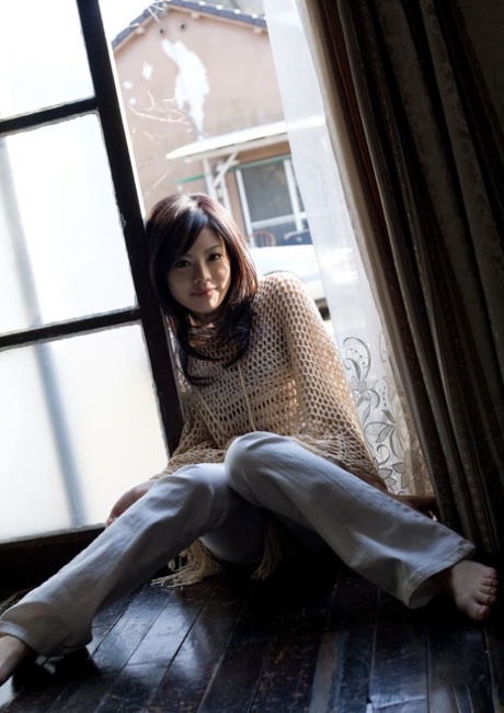 China Yuki, an attractive Japanese girl, is seen getting dressed up while lying naked on her bed.