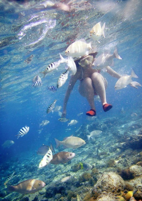 While hanging out on the beach, Nao Yoshizaki, a Japanese model, indulges in a skinny dipping experience.