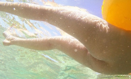 In a photo taken at the beach, Nao Yoshizaki, a Japanese model, is seen skinny-dipping.