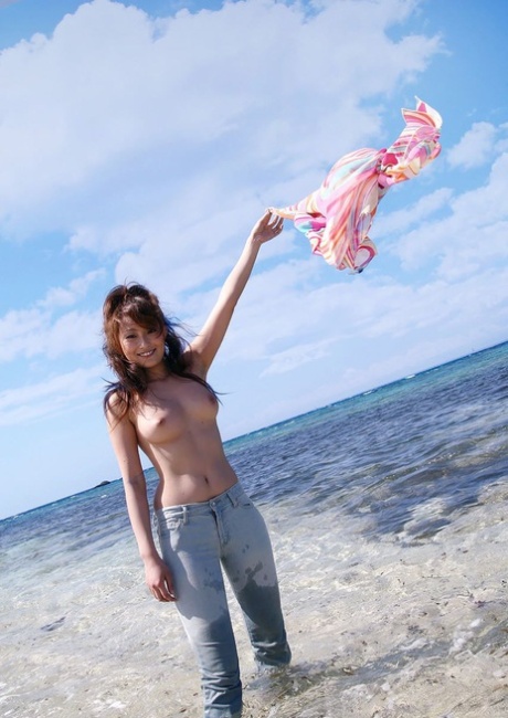 Japanese model Nao Yoshizaki goes for a swim at the beach in Japan.