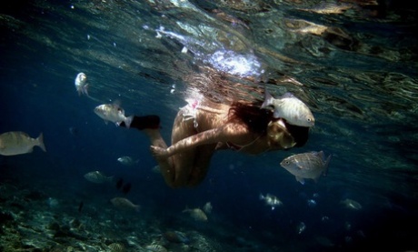 Nao Yoshizaki, a Japanese model, engages in some swimming while hanging out on the beach.