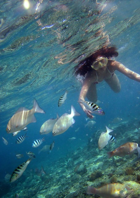 At the beach, Nao Yoshizaki from Japan engages in a swimming and dipping routine.