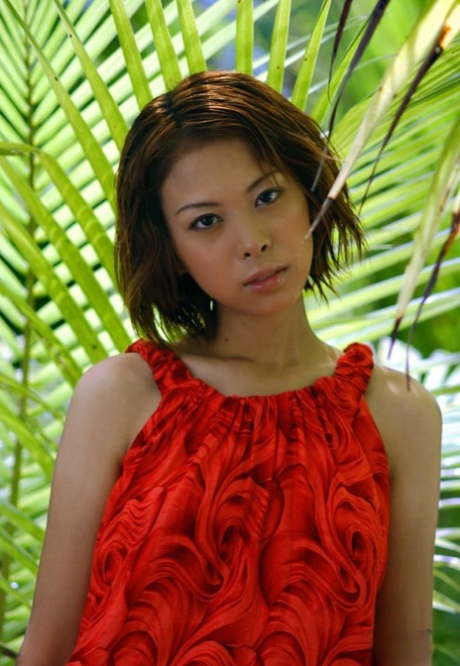 Minami Aikawa, a beautiful and attractive Japanese girl, exhibits her lively tits in front of lush greenery.