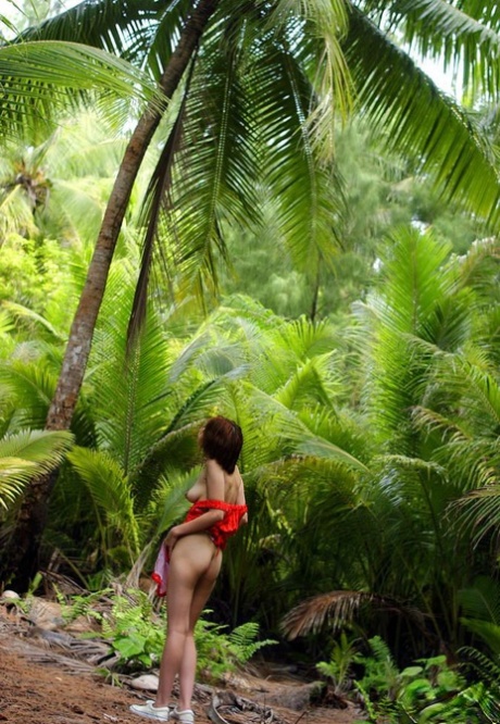 In a lush green environment, Japanese woman Minami Aikawa displays her lively tits.