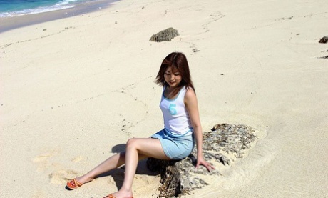 Miyu Sugiura, a beautiful Japanese girl, exposes her buttocks while wearing sand.