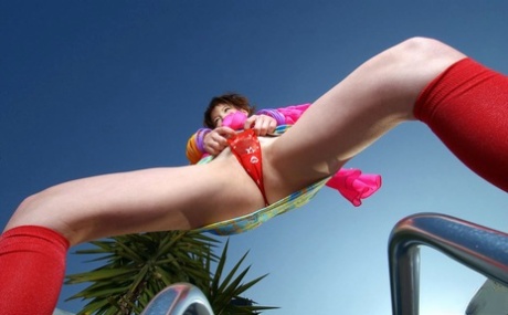 Japanese girl Akane Sakura exposes her upskirt underwear near a backyard fence