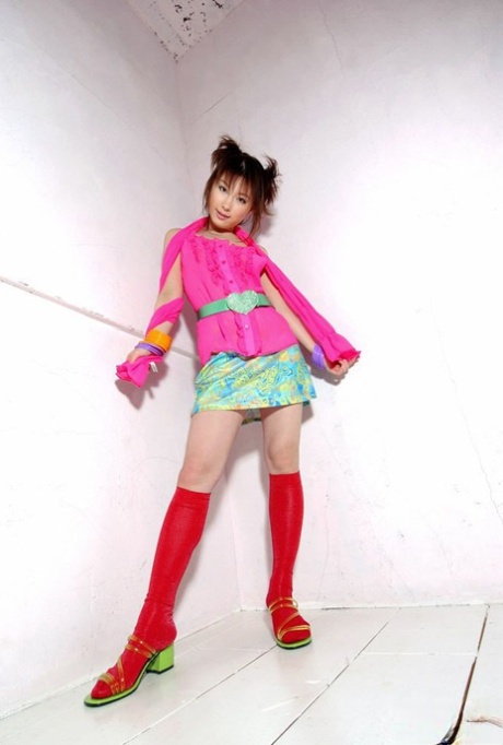 Japanese girl Akane Sakura exposes her upskirt underwear near a backyard fence