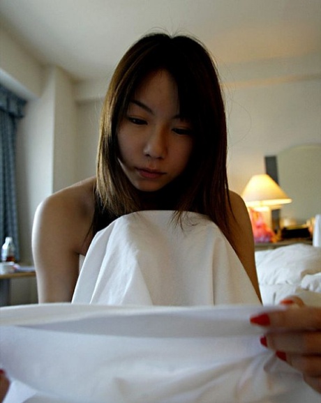 A Japanese girl named Kurumi Morishita shows off her firm tits as she gets changed.