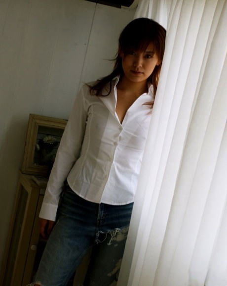 Hot Japanese teen with a phat ass Kana partially disrobes on a loveseat