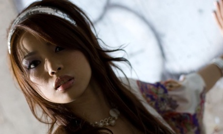 While performing solo, Risa Kasumi showcases her tits and twat in an alluring display.
