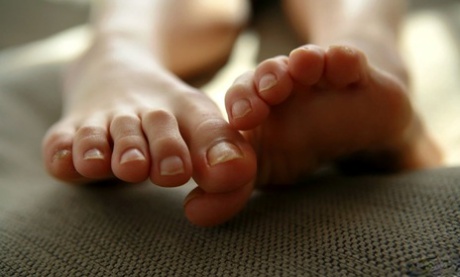 Momo Yoshizawa, a young Japanese girl, displays her lovely toes before being nude.