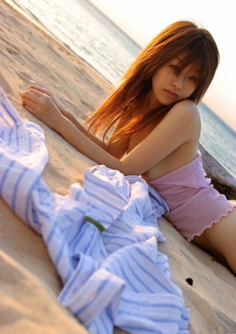 Cute Nagsa Sasaki from Japan is seen naked in her bathroom and on a beach.