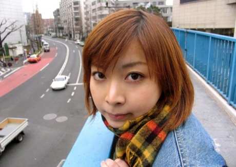 After exploring the streets, Kyoko, a Japanese redhead, gets completely naked and takes a bath.