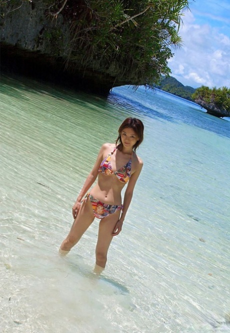 The nakedness of Japanese redhead Ray Ito is exhibited by her on a tropical beach, complete with all clothing on.