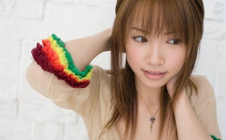 The Japanese redhead Reika Shiina wears a transparent gown that displays her breast.