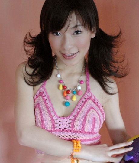 Adorable Japanese girl: Kaho flaunts her firm tits during solo gigs.