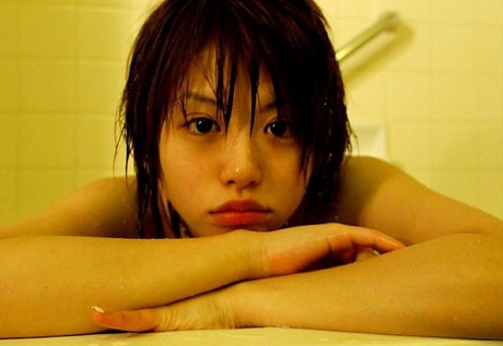 MILF Hitomi Hayasaka, an Asian, performs great nude poses in a bath.