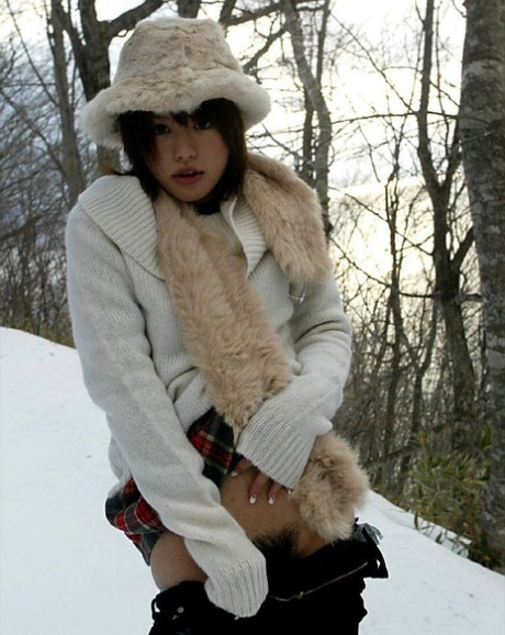 Cute Hitomi Hayasaka, a Japanese girl of note, pees on the snow before going home.