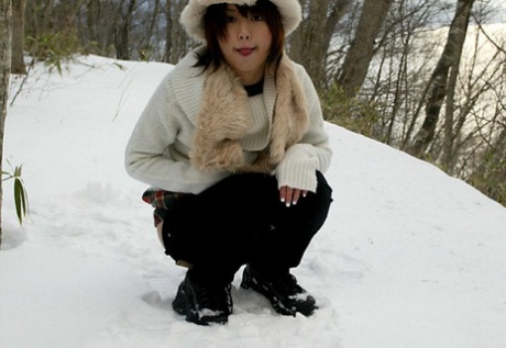 Adorable Japanese girl: Hitomi Hayasaka (left) pees on the snow before heading back home.