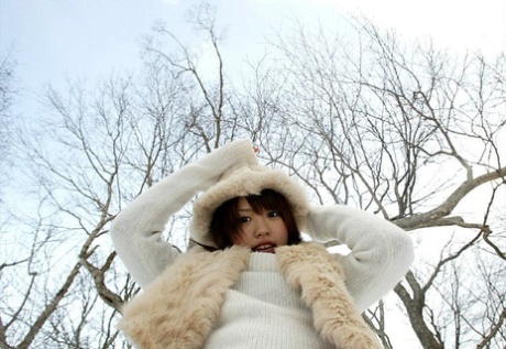 Hitomi Hayasaka, an adorable Japanese girl, urinates on the snow before going back home.