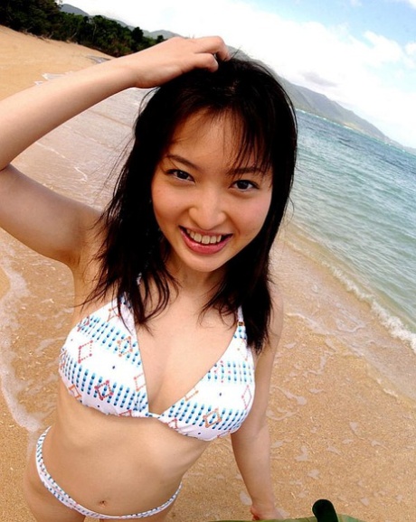 In the woods and on the beach, a Japanese beauty displays her impressive tits and bush.