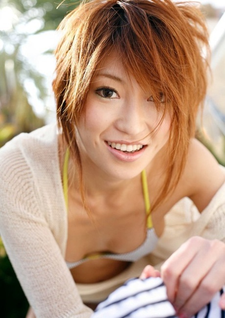 Yu Saotome, a red-haired Japanese girl who is alone, walks around in a bikini and sports a hat.