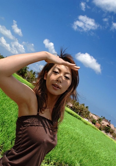 In the countryside, Honoka, a young Japanese girl, displays her great tits while exploring the countryside.