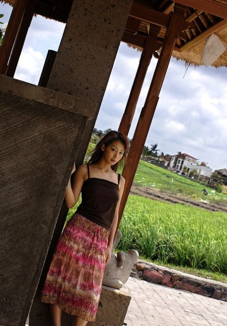 Honoka, a young Japanese girl, displays her great tits while exploring the countryside.