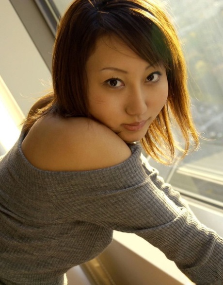 Japanese teen Shiho soaps up her bush while taking a bath after arriving home