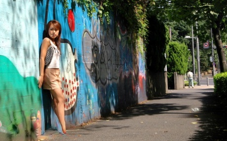 Mao, a Japanese redhead from China, exposes herself during candid action near her home.