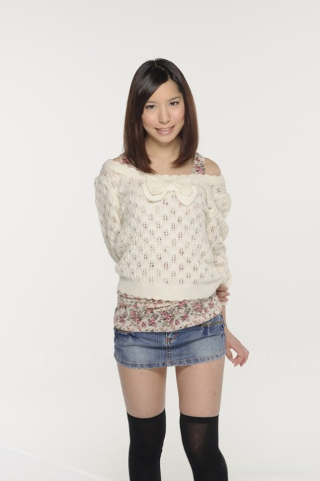 Wearing an upskirt panties, Kurara Makise, a Japanese girl, models a denim skirt and OTK socks.