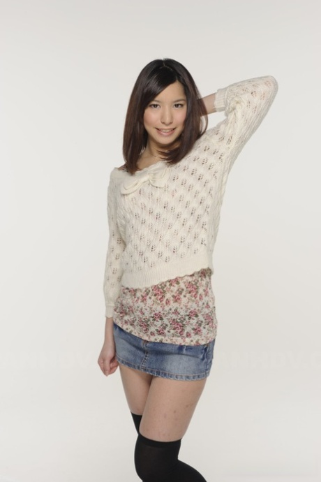 In a pair of upskirt panties, Kurara Makise, a Japanese girl, models a denim skirt and OTK socks.